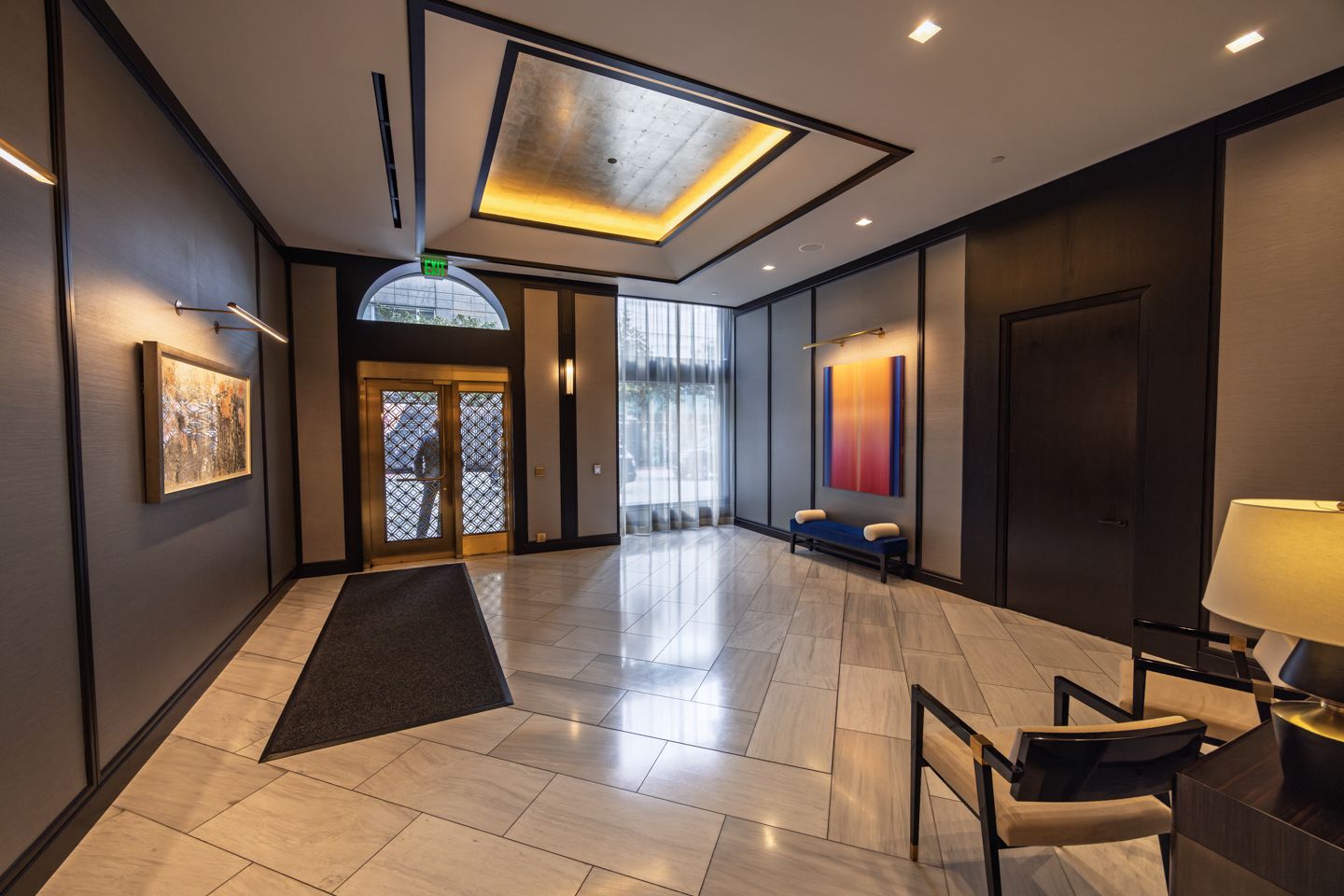 Attended residential lobby at 706 Mission with warm stone and millwork